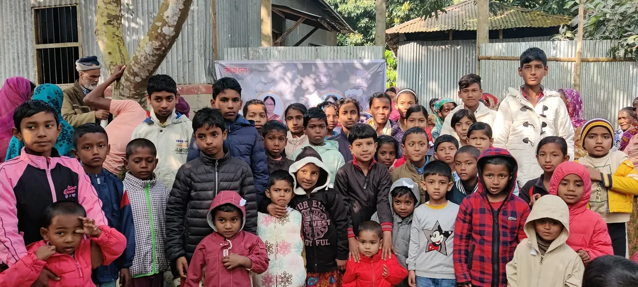 Children from Chatlarpar at a winter-clothes drive Arafat organised.